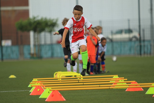 Boy running through speed hurdles